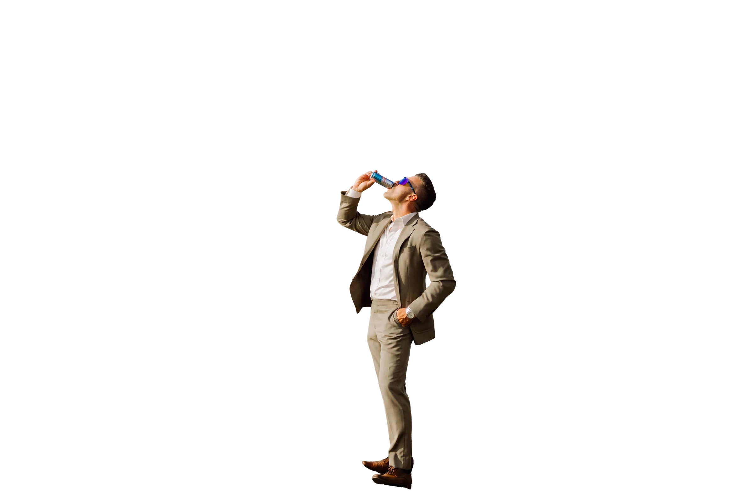 Jeff Maeck raising a Red Bull while standing on a coastal cliff